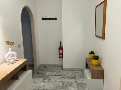 a hallway with a table and a fire extinguisher at FAIROME Apartment Albricci in Rome
