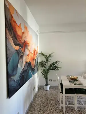 a dining room with a painting on the wall at FAIROME Apartment Albricci in Rome