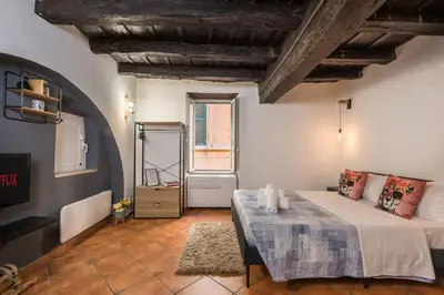 a window view of an alley with a potted plant at SorinaHome Campo de Fiori Loft in Rome