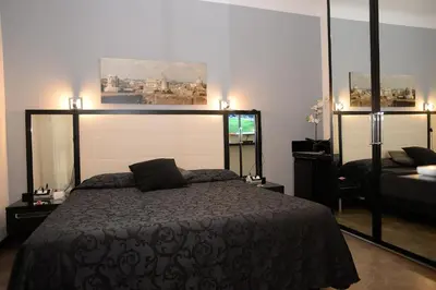 a bedroom with a bed with a black bedspread at Capital Suite in Rome