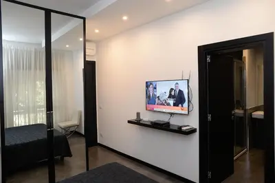 a room with a flat screen tv on a wall at Capital Suite in Rome