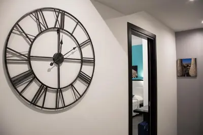 a large clock on a wall next to a door at Capital Suite in Rome