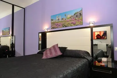 a bedroom with a bed with a pink pillow at Capital Suite in Rome