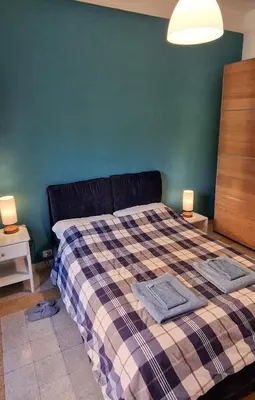 a bedroom with a bed with two towels on it at Green House in San Lorenzo Termini in Rome