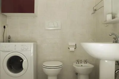 a bathroom with a washing machine and a sink at Green House in San Lorenzo Termini in Rome