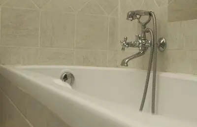 a bath tub with a shower in a bathroom at Green House in San Lorenzo Termini in Rome