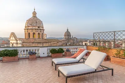 a patio with benches and a view of a building at Arenula16 - Attico con terrazza panoramica in Rome