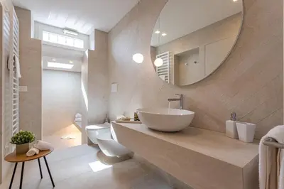 a bathroom with a sink and a toilet and a mirror at Arenula16 - Attico con terrazza panoramica in Rome