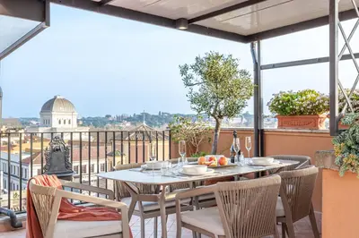 a living room with a blue couch and a table at Arenula16 - Attico con terrazza panoramica in Rome