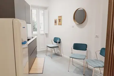 a kitchen with three chairs and a mirror at Zoe Vatican rooms in Rome