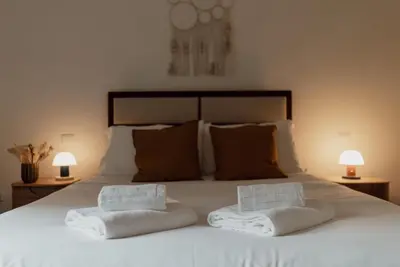 a bedroom with a white bed with two towels on it at Zoe Vatican rooms in Rome