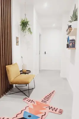 a living room with a chair and a rug on the floor at Zoe Vatican rooms in Rome