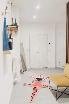 a living room with a table and a chair at Zoe Vatican rooms in Rome