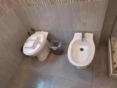 a bathroom with a toilet and a bidet and a sink at Kotel lorenzo il magnifico in Rome