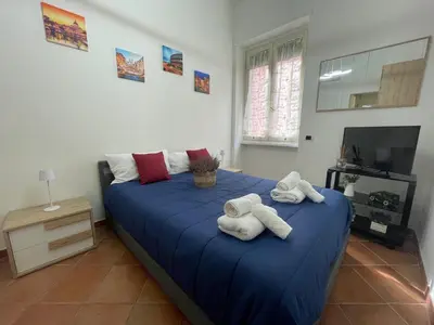 a bedroom with a blue bed with towels on it at Appartamento Monteverde in Rome