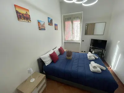 a bedroom with a blue bed with towels on it at Appartamento Monteverde in Rome