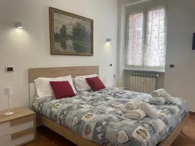 a bedroom with a large bed with towels on it at Appartamento Monteverde in Rome