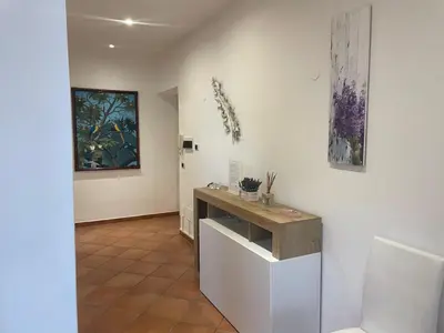 a room with a counter and paintings on the wall at Appartamento Monteverde in Rome
