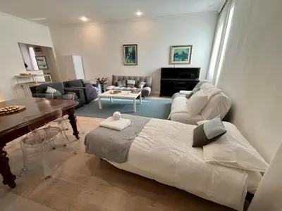 a living room with a bed and a couch and a table at GDR Apartment - City Center in Rome