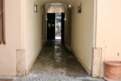 an alley way with a door and a person walking down it at Home Sweet Rome Lucina in Rome