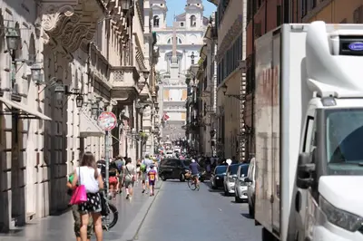 a group of people riding bikes down a city street at Home Sweet Rome Lucina in Rome