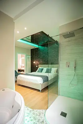 a bedroom with a bed and a shower and a tub at Rome suite Rome Vaticano Guest house in Rome