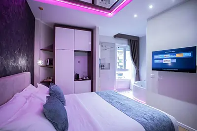 a bedroom with a bed and a tv and a tub at Rome suite Rome Vaticano Guest house in Rome