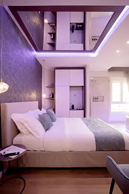 a bedroom with a large white bed with purple ceilings at Rome suite Rome Vaticano Guest house in Rome
