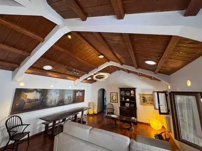 a living room with wooden ceilings and a table and chairs at Domus Colosseum, detached house just few steps from the Colosseum in Rome