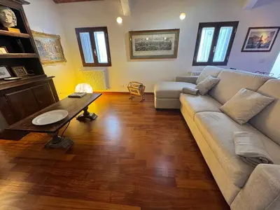 a dining room with a large painting on the wall at Domus Colosseum, detached house just few steps from the Colosseum in Rome
