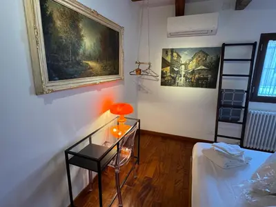 a room with a glass table and a painting on the wall at Domus Colosseum, detached house just few steps from the Colosseum in Rome
