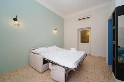 a hospital room with a bed and a tv at St Lawrence by BuddyRent in Rome