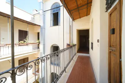 a balcony in a building with a wooden door at St Lawrence by BuddyRent in Rome
