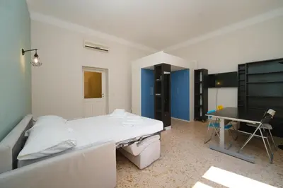 a hospital room with a bed and a desk at St Lawrence by BuddyRent in Rome