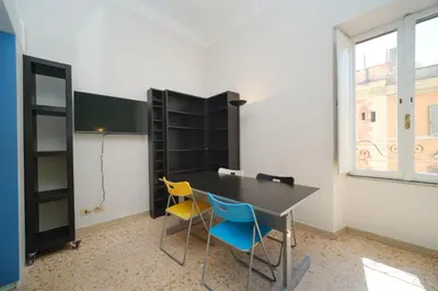 a room with a table and two chairs at St Lawrence by BuddyRent in Rome