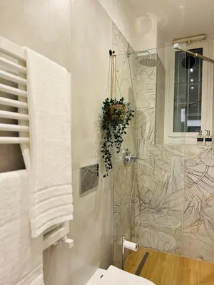 a bathroom with a shower with a glass door at Friendly Apartment San Saba in Rome