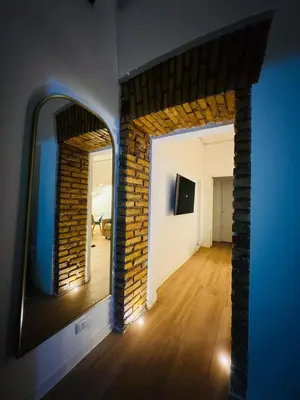 a room with a mirror and a brick wall at Friendly Apartment San Saba in Rome