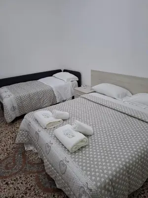two beds in a room with towels on them at APARTAMENTo FANTI22 in Rome