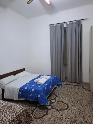 a bedroom with a bed with a blue blanket on it at APARTAMENTo FANTI22 in Rome
