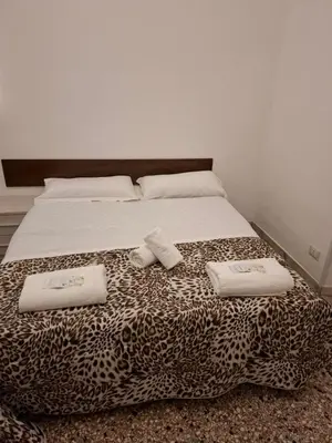 a bed with two towels on top of it at APARTAMENTo FANTI22 in Rome