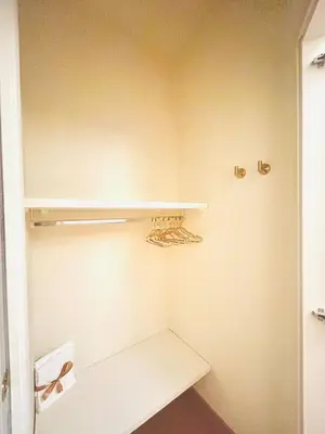 a small closet with white shelves in a room at TritHome in Rome