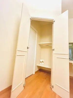 a closet with white doors and a wooden floor at TritHome in Rome