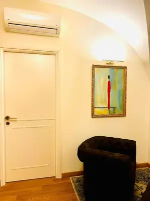 a room with a door and a painting and a chair at TritHome in Rome