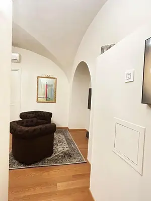 a living room with a chair and a wall at TritHome in Rome