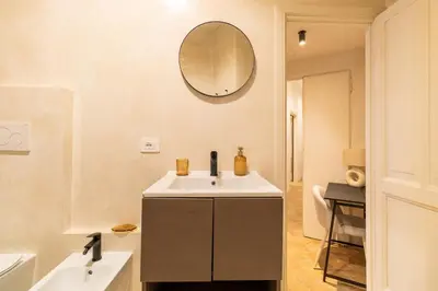 a bathroom with a sink and a mirror on the wall at Cunabu Morosini in Rome