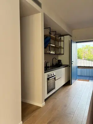 a kitchen with a stove top oven next to a window at Residenza Labicana Luxury Apartment- Free Parking in Rome