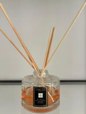a glass jar with sticks in it on a table at Residenza Labicana Luxury Apartment- Free Parking in Rome