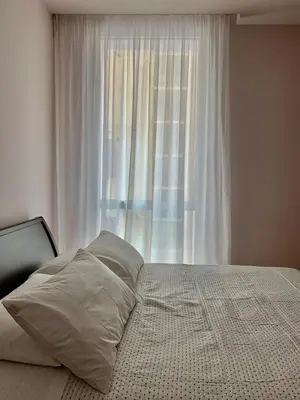 a bed with pillows in front of a window at Residenza Labicana Luxury Apartment- Free Parking in Rome