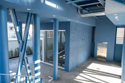 a hallway of a building with blue columns at Residenza Labicana Luxury Apartment- Free Parking in Rome