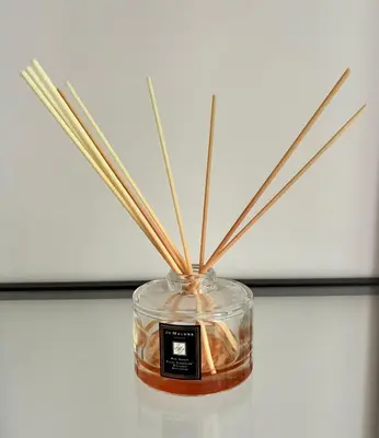 a glass jar with sticks in it on a table at Residenza Labicana Luxury Apartment- Free Parking in Rome